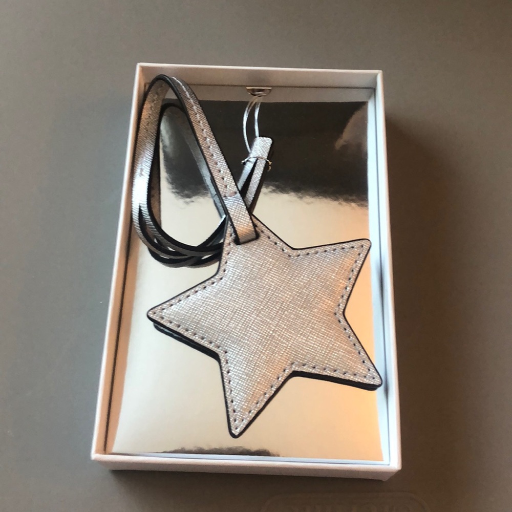 A Michael kors silver star monogram charm